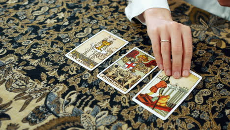 a woman giving a tarot reading with the ace of cups judgement and the six of swords cards