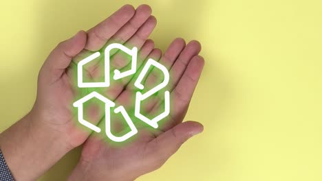 think green: computer-generated recycling symbol revealed in hands