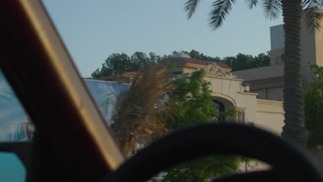 car driving by a wall art of the saudi royal family 4k