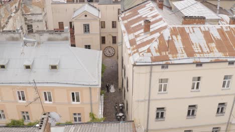 aerial view of a wedding couple walking down a street in the city