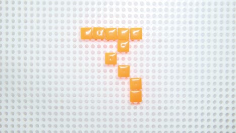 stop motion of the number 3 creating one pixel at the time, made with children toys