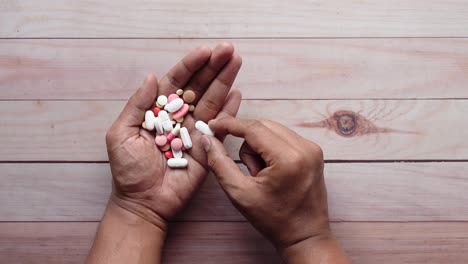 hands holding various pills