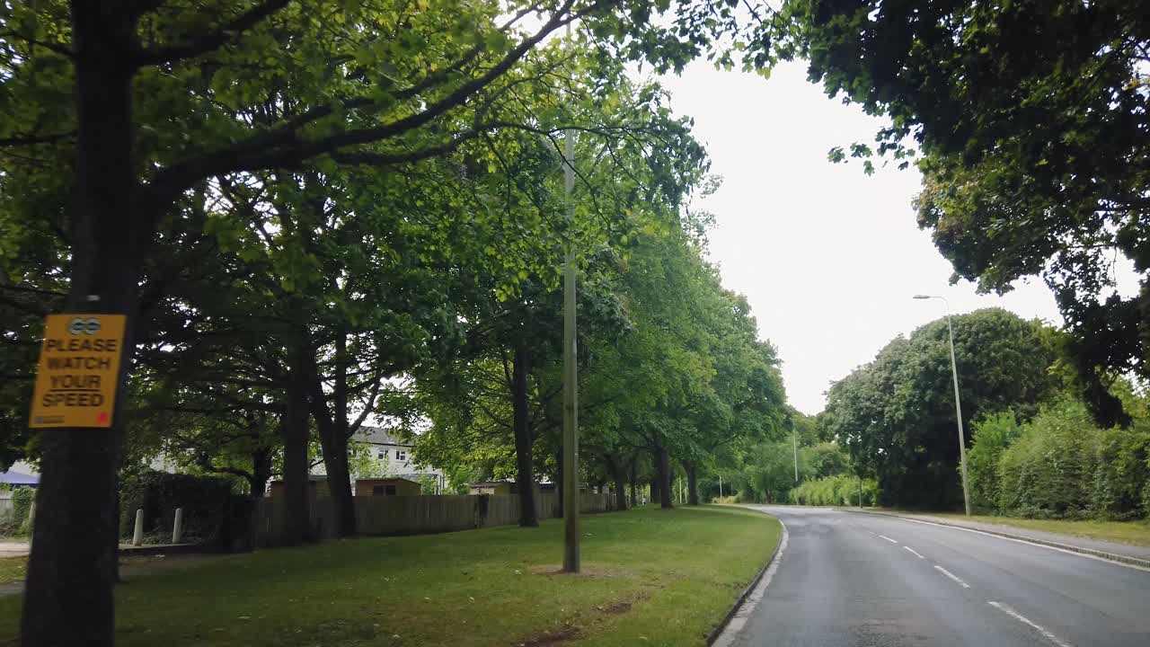 Cycling on a quiet, empty road in a small British town on a cloudy day