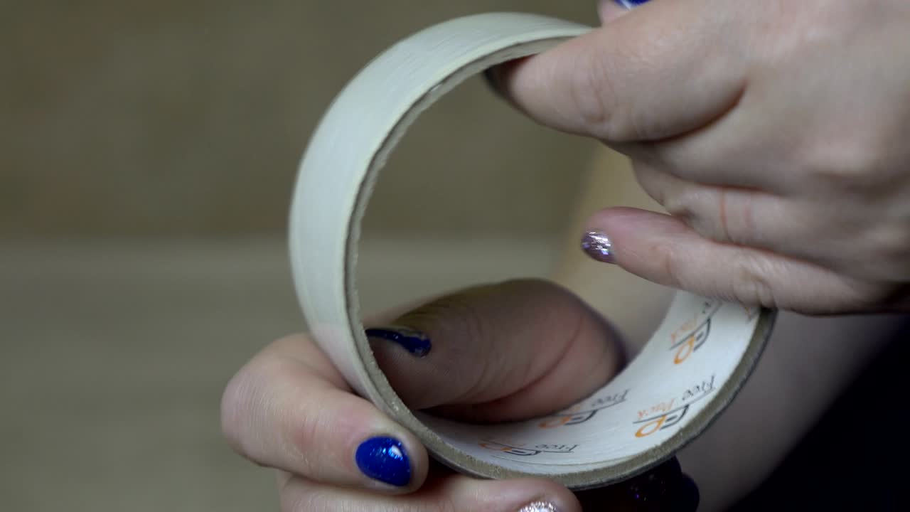 Female hands with scotch tape