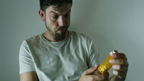 mentally ill man holding pills in an asylum