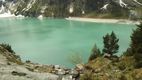 pan up following a river running into the oeschinensee in switzerland