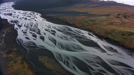 aerial view of a braided glacial river delta in a volcanic landscape