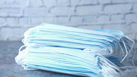 stack of blue disposable medical masks