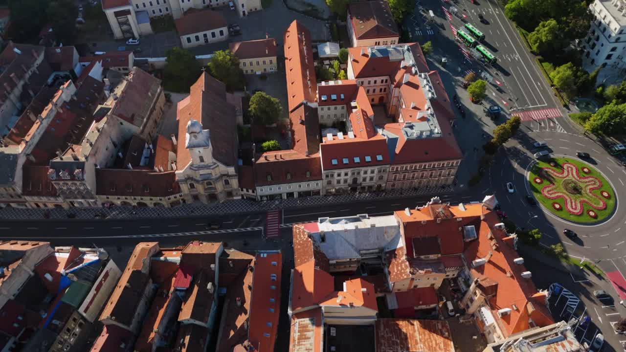 Scenic aerial view over historic city rooftops and roundabout in sunlit setting