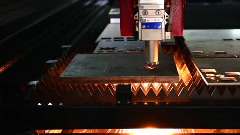 industrial laser cut machine while cutting the sheet metal with the sparking light.