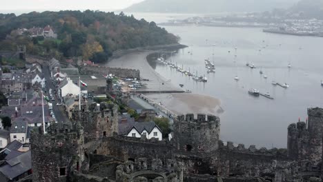 historic conwy castle aerial view of landmark town ruin stone wall battlements tourist attraction descending skyline shot