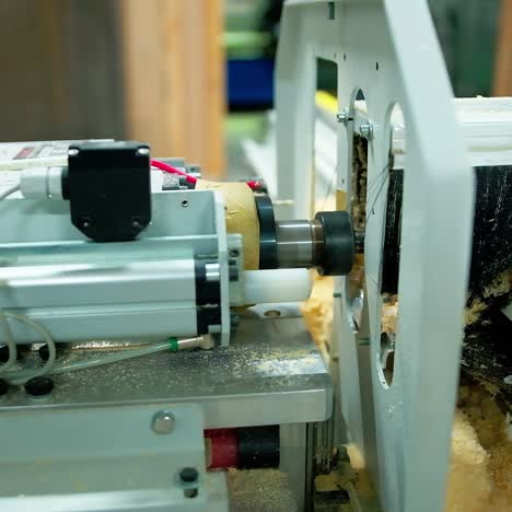 industry for making doors. modern automated machine doing holes in wooden doors. furniture production in workshop. close-up.