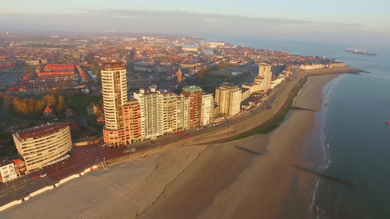 Aerial: The boulevard, beach and city of Vlissingen during sunset