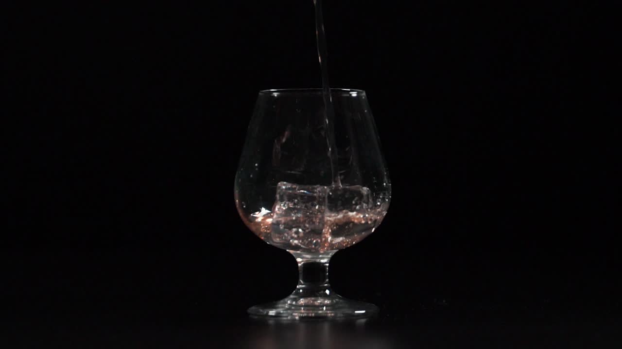Filling Glass with Drink on the Rocks Slow Motion 4K