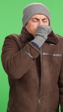 Man coughing, expressing discomfort, isolated on green screen background