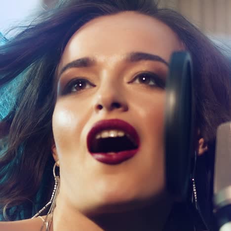 woman singing in a recording studio. female vocals. professional recording studio. slow motion