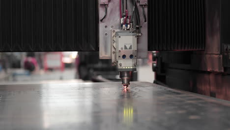 cutting metal sheet in a workshop using laser cutting machine - close up