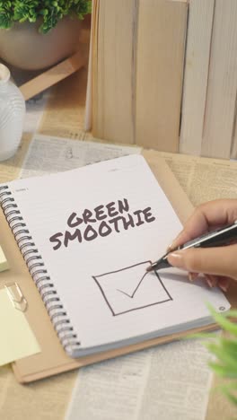 vertical video of ticking off green smoothie from checklist