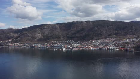 Slow-aerial-orbit-Sandviken-with-Skuteviksboder-and-Stoltzekleiven-mountain-behind---Norway