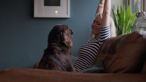 woman petting her dog on the couch