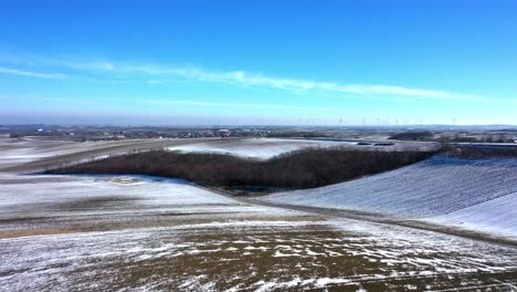 Drone-Fly-Fast-Over-Snow-Fields-Revealing-Zistersdorf-Town-In-Weinviertel-Wine-Quater,-Lower-Austria