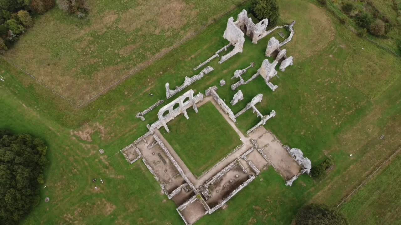 Aerial drone shot of Old Bayham Abbey, Kent. Rising view reveals historic ruins surrounded by lush countryside—perfect for travel, history, or cinematic projects
