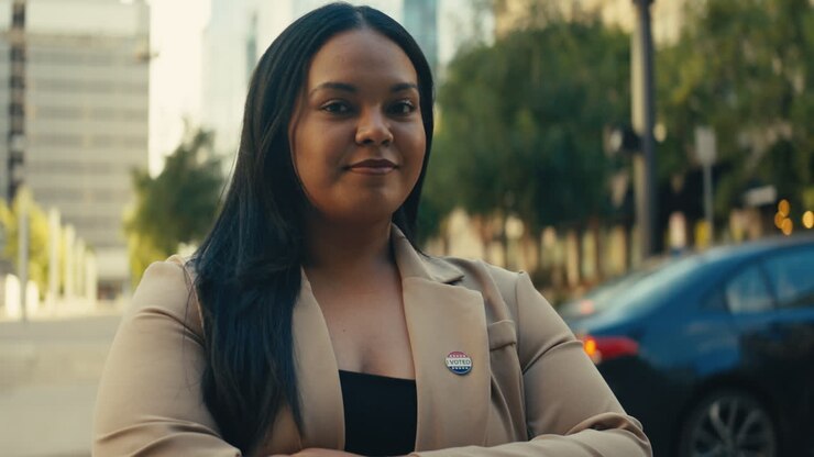 Woman with I Voted sticker in urban setting