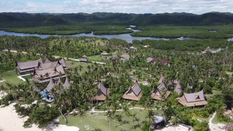 Beachfront-traditional-villa-huts-of-Nay-Palad-resort-on-Siargao-island,-Aerial