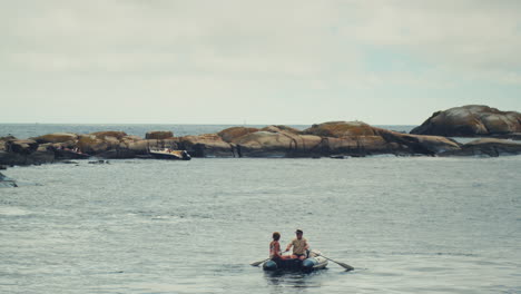 Older-couple-rowing-against-the-current-in-the-archipelago