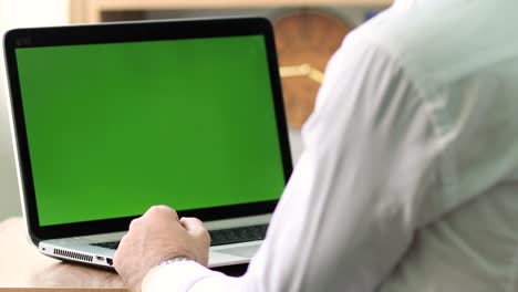office man watching movie on green screen laptop