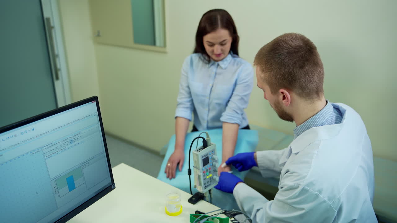 Female patient at doctor office. Male doctor with female patient during medical treatment in clinic