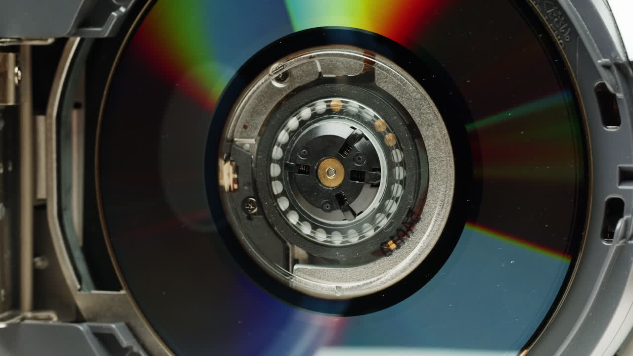 Vintage video-camera with disk inside rotating on black background close-up. Using portable camcorder to shooting videos