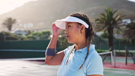 woman taking a break on tennis court