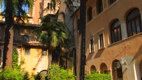 Tilt-down-shot-of-beautiful-garden-in-the-courtyard-beside-Palazzo-Venezia-in-Rome,-Italy-at-daytime