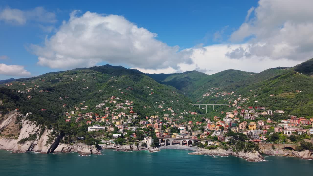 Charming coastal Italian town by mountains and sea under a bright blue sky