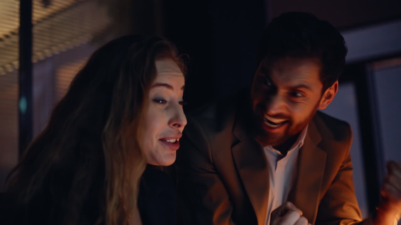 Portrait overtime workers rejoicing winning achievement. Managers giving five