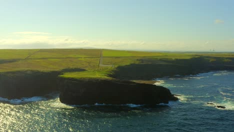 aerial orbit from the sea around the kilkee cliffs headland, co clare, ireland