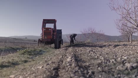 farmer digging ground in rural field in countryside