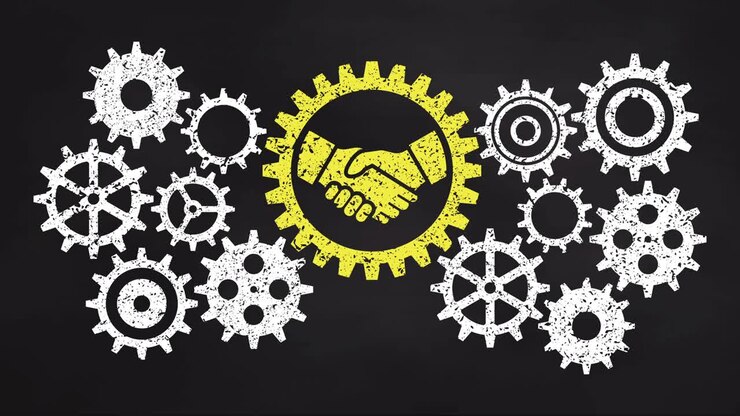 Business gear mechanism concept on blackboard. Yellow handshake icon