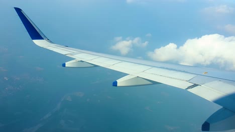 View-of-airplane-wing-from-window,-flying-mid-air