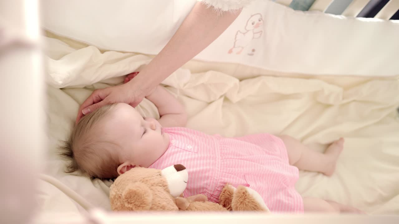 Baby sleep time. Toddler girl rest in cot. Little baby dream in crib