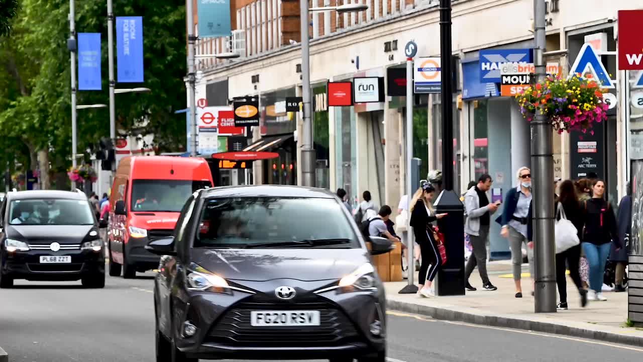 Busy London Street Scene with Traffic, Shops, and Pedestrians