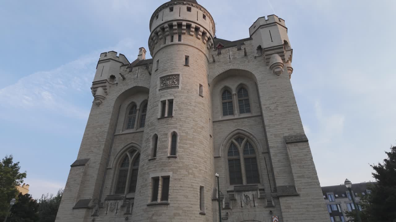 Low angle view of the historic Halle Gate in Brussels, showcasing its medieval architecture and imposing presence within the urban landscape.Tilt up Shot