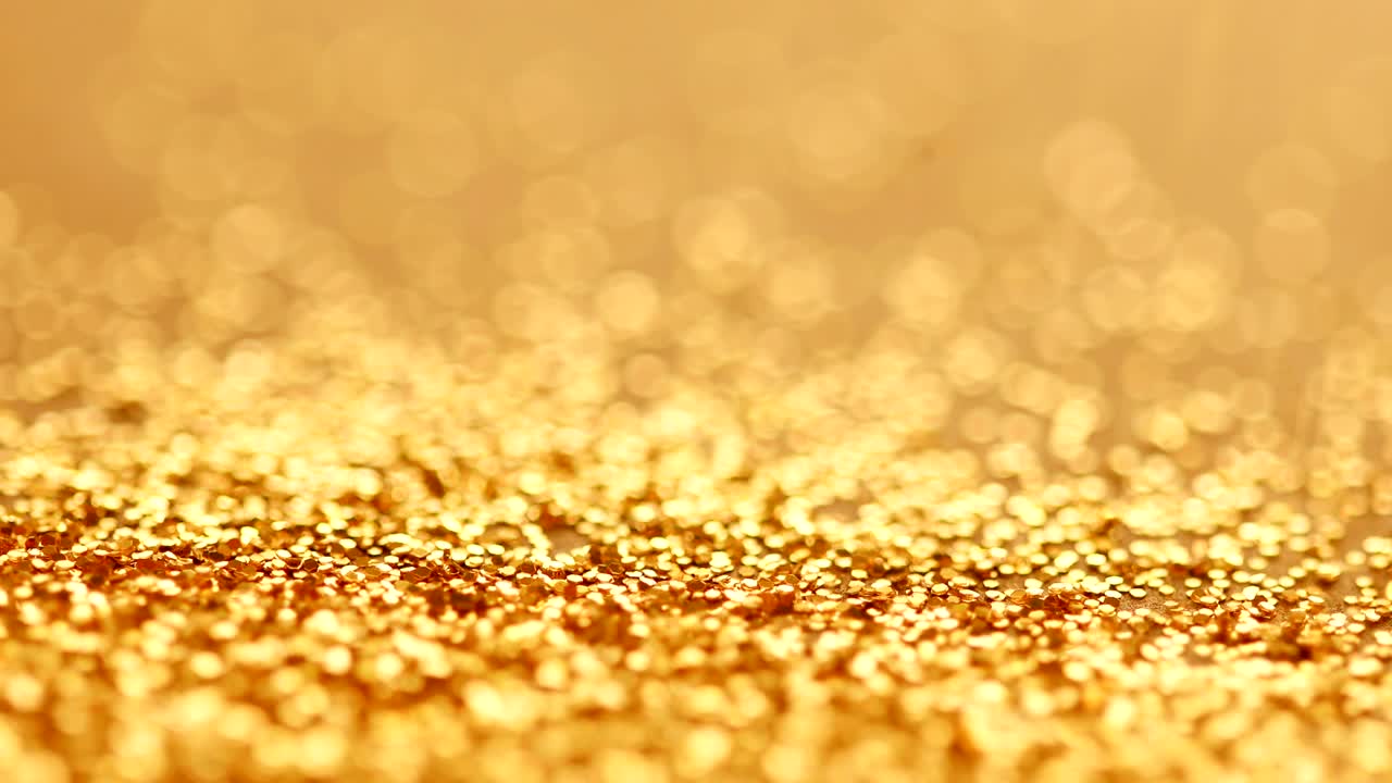 the luxury gold glitter sparkle shining falling on to the floor background , festival and celebration background concept , 4K Dci resolution
