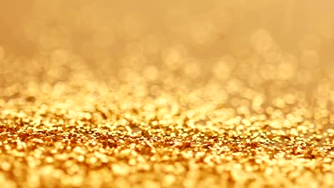 the luxury gold glitter sparkle shining falling on to the floor background , festival and celebration background concept , 4k dci resolution