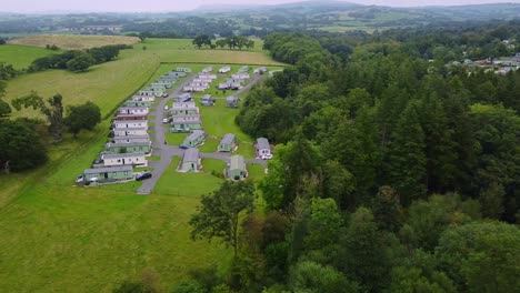 aerial pan of caravan park in uk countryside on cloudy day