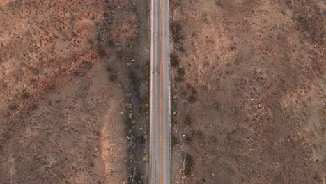 Desert-Road-Surrounded-by-Shrubs-and-Rocks