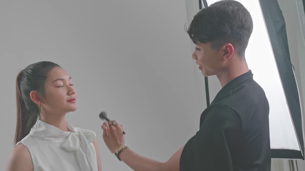 Backstage Of The Photo Shoot: Make-Up Artist Applies Makeup On Beautiful Asian Model