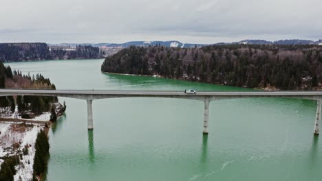 bridge over a lake on a snowy winter day