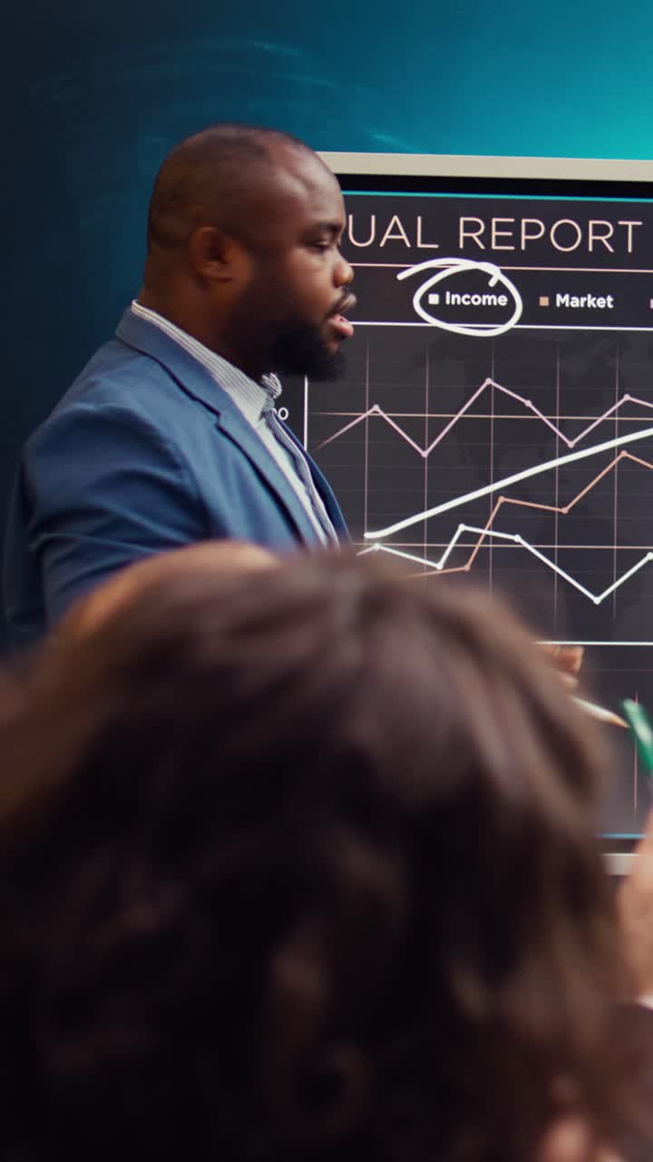 African American Businessman Presenting Annual Report Graphs in Office Meeting